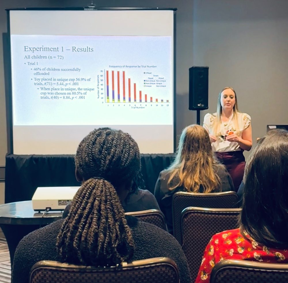 Elizabeth presenting experiment results to a conference audience